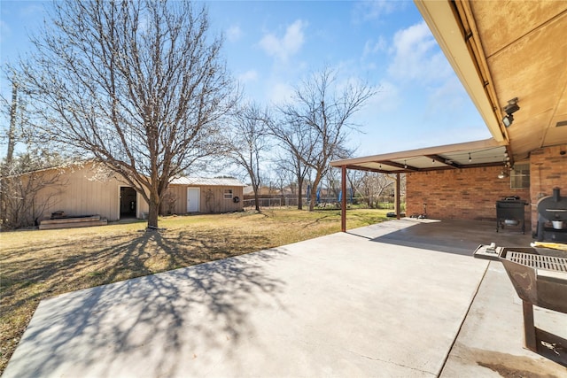 view of patio with driveway and fence