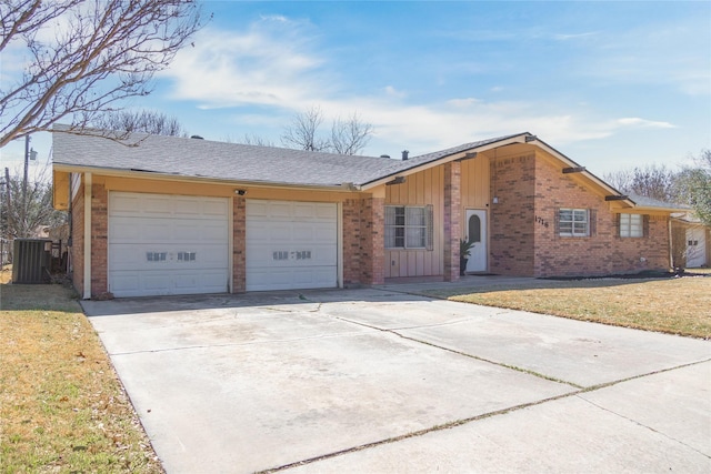 view of front of home with brick siding, board and batten siding, concrete driveway, cooling unit, and an attached garage