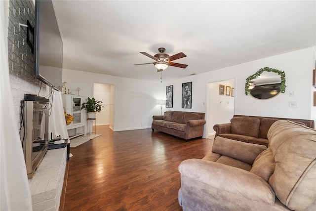 living area featuring a ceiling fan, wood finished floors, and baseboards