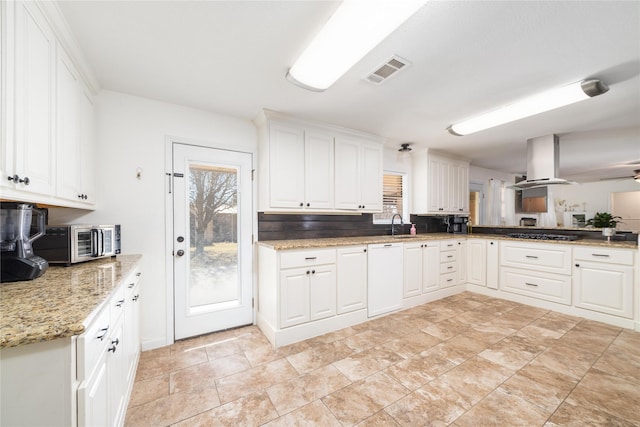 kitchen featuring visible vents, a toaster, island exhaust hood, white cabinetry, and gas cooktop