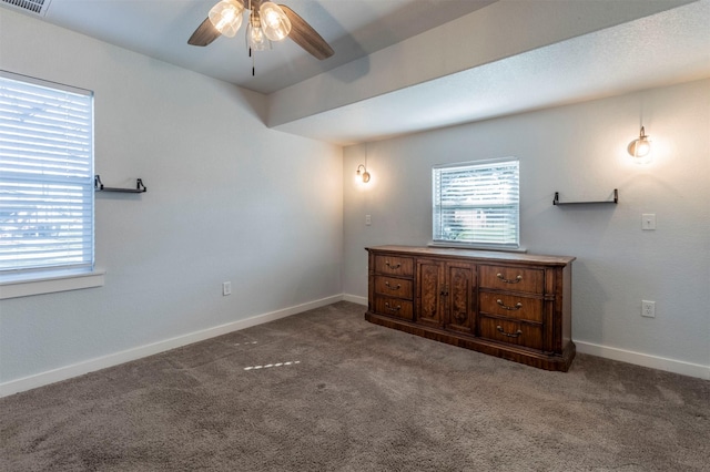 unfurnished bedroom featuring visible vents, baseboards, and carpet