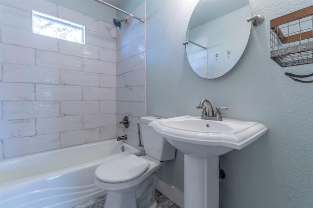 full bathroom with toilet, a textured wall, and shower / bathtub combination