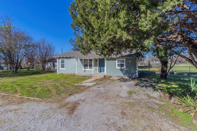 view of front of home with a front lawn and fence