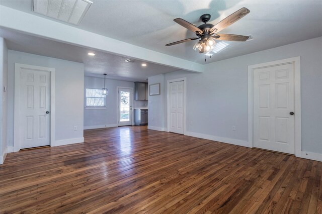 unfurnished living room with a ceiling fan, dark wood-style floors, visible vents, baseboards, and recessed lighting