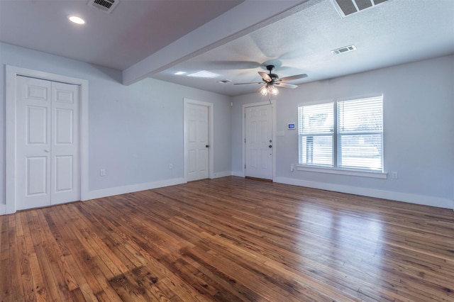 empty room with visible vents, baseboards, and wood finished floors