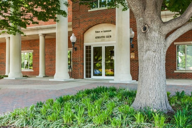 entrance to property featuring brick siding