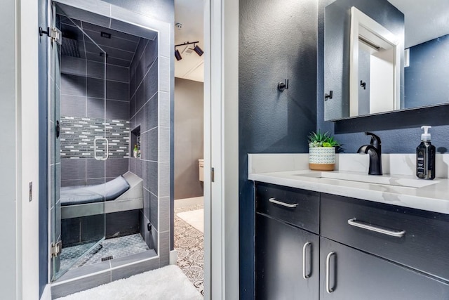 full bath featuring a stall shower and vanity