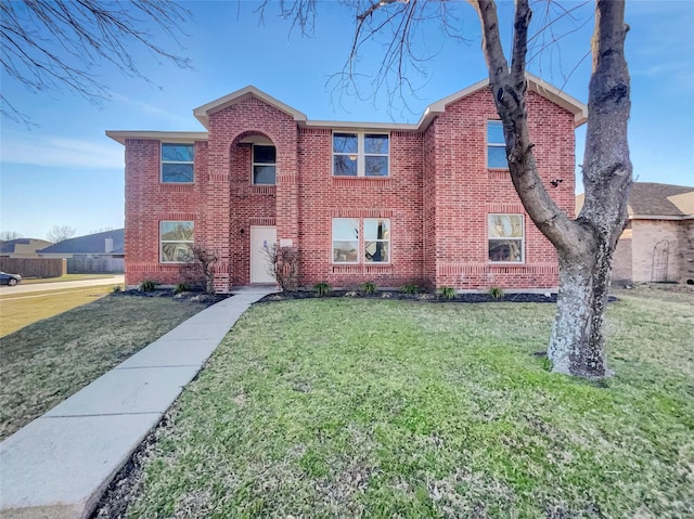 view of front of house with brick siding and a front lawn