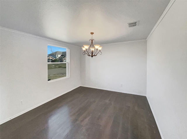 unfurnished room with a chandelier, visible vents, wood finished floors, and crown molding