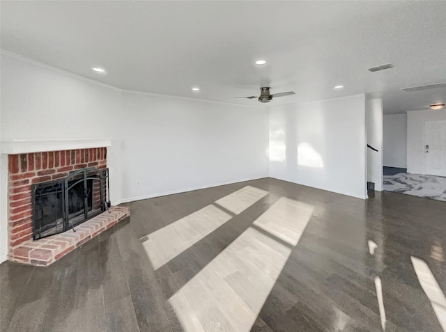 unfurnished living room with visible vents, a ceiling fan, wood finished floors, recessed lighting, and a brick fireplace