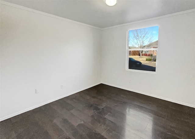 unfurnished room featuring baseboards, dark wood-style floors, and crown molding