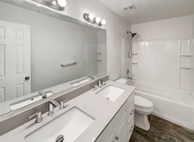 bathroom featuring a sink, visible vents, toilet, and shower / washtub combination