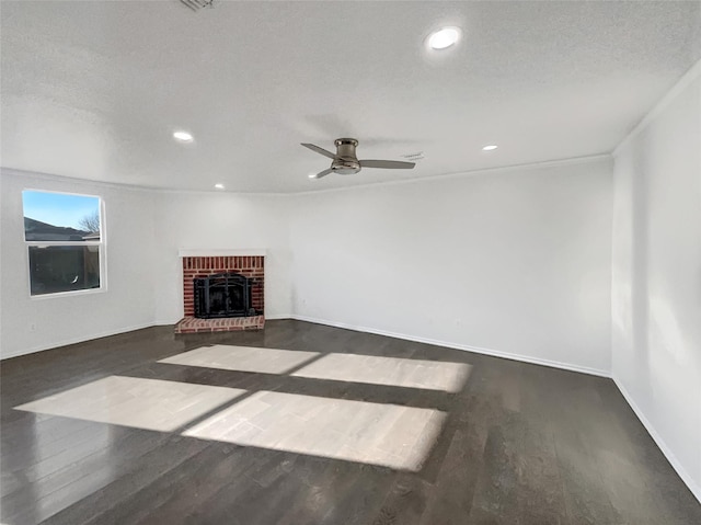 unfurnished living room featuring recessed lighting, a fireplace, baseboards, and wood finished floors