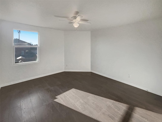 unfurnished room with ceiling fan, baseboards, and wood finished floors