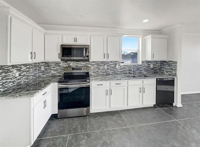 kitchen with tile patterned flooring, tasteful backsplash, appliances with stainless steel finishes, white cabinets, and a sink