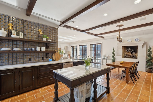 kitchen featuring dark brown cabinetry, beamed ceiling, dishwasher, pendant lighting, and an inviting chandelier