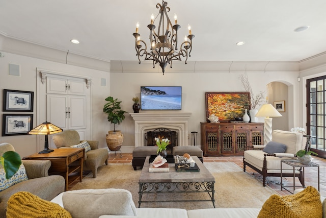 living room featuring recessed lighting, arched walkways, a lit fireplace, and crown molding