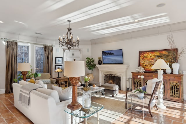 living room with a notable chandelier, visible vents, and a lit fireplace