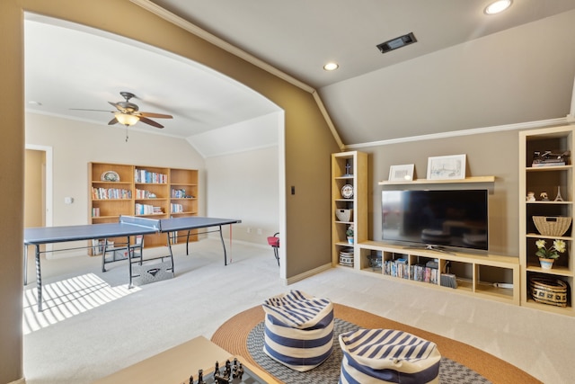 game room featuring built in features, visible vents, lofted ceiling, ornamental molding, and carpet flooring