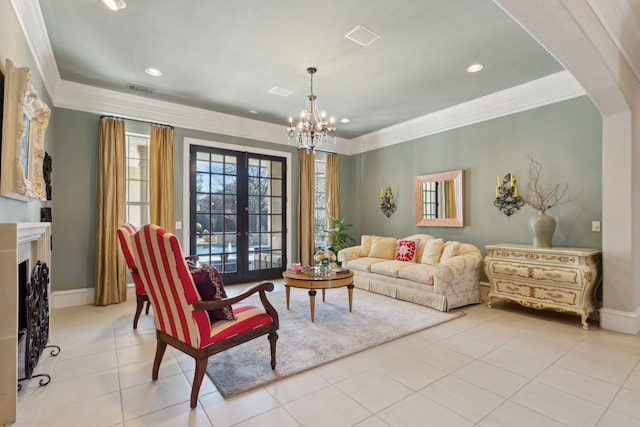 living area featuring arched walkways, visible vents, french doors, and ornamental molding