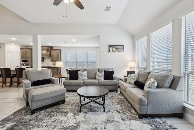 living area with visible vents, recessed lighting, light tile patterned floors, lofted ceiling, and ceiling fan