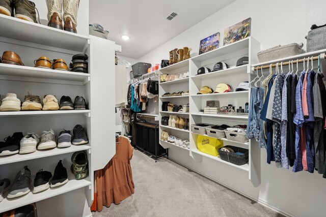 spacious closet featuring visible vents and carpet floors