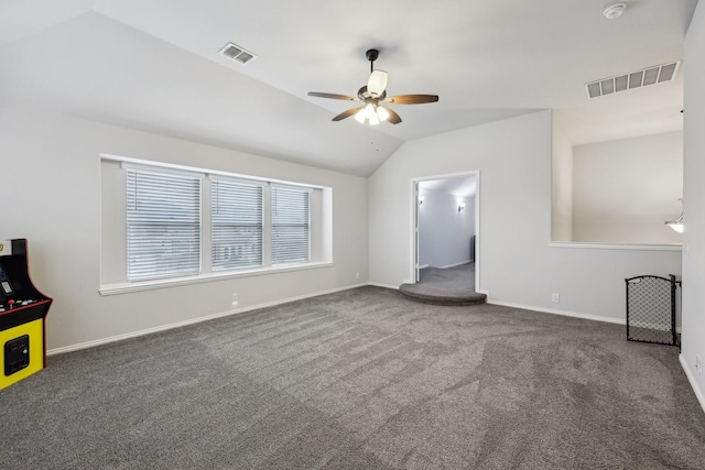 unfurnished living room with visible vents, carpet flooring, and vaulted ceiling