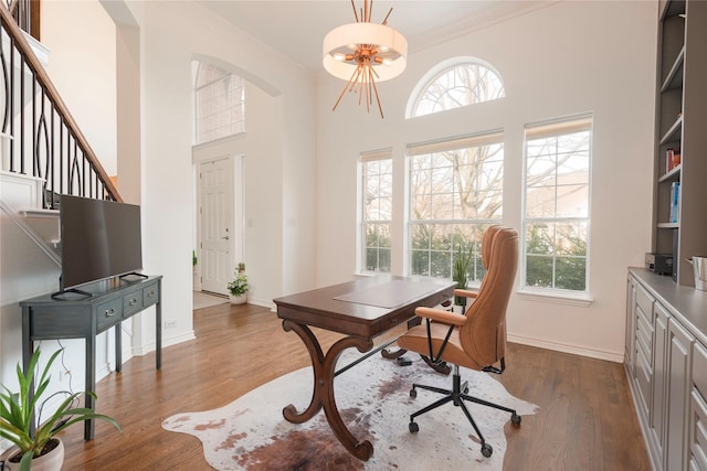 home office with dark wood-style floors, plenty of natural light, and crown molding