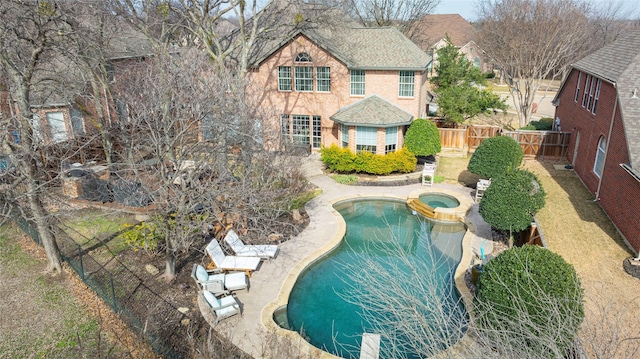 view of pool with a patio, a gate, fence, and a pool with connected hot tub