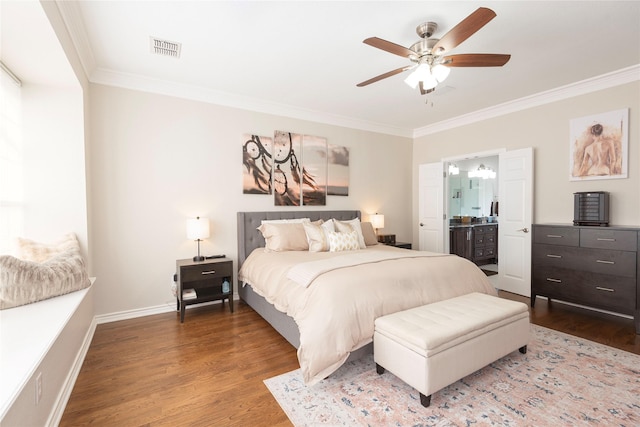 bedroom with visible vents, ornamental molding, baseboards, and wood finished floors