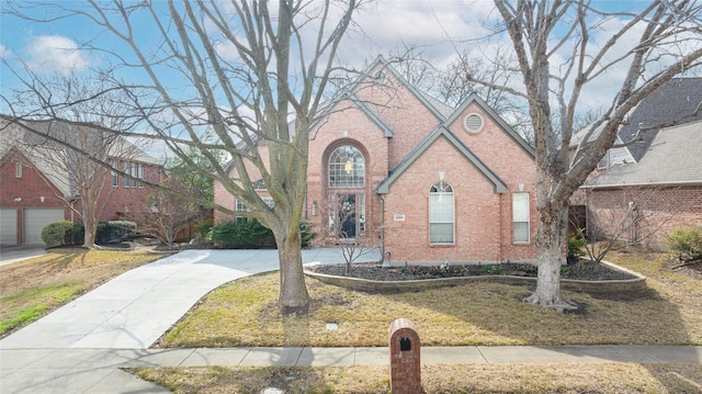 view of front of home with brick siding and a front lawn