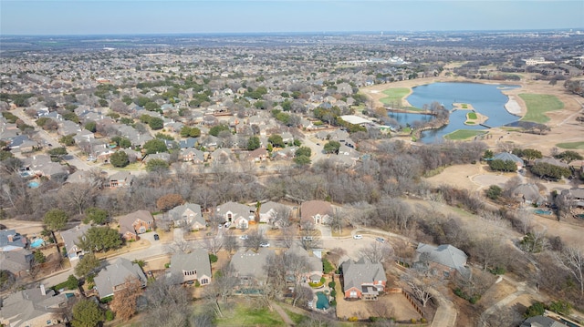 drone / aerial view with a water view and a residential view