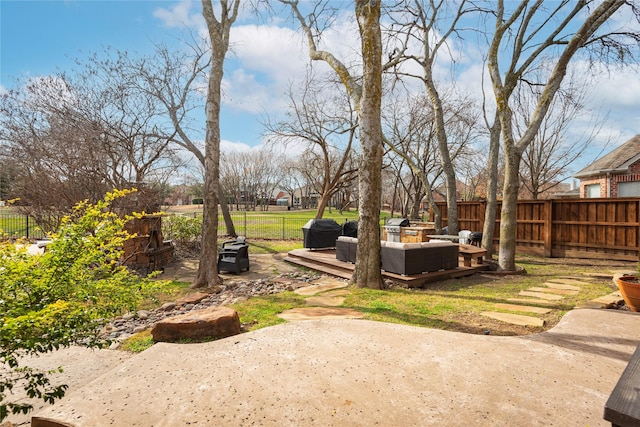 view of yard featuring a deck, a fenced backyard, and outdoor lounge area