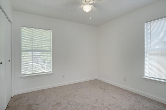 unfurnished room featuring baseboards, a ceiling fan, and carpet flooring