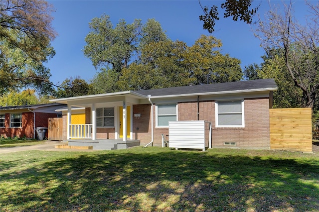 view of front of property with brick siding, a porch, and a front yard