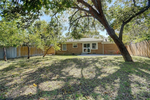 view of yard with a patio area and a fenced backyard