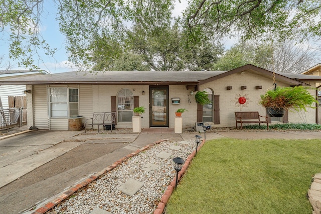 ranch-style house with brick siding and a front lawn