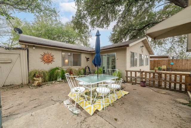 view of patio / terrace featuring outdoor dining area and fence