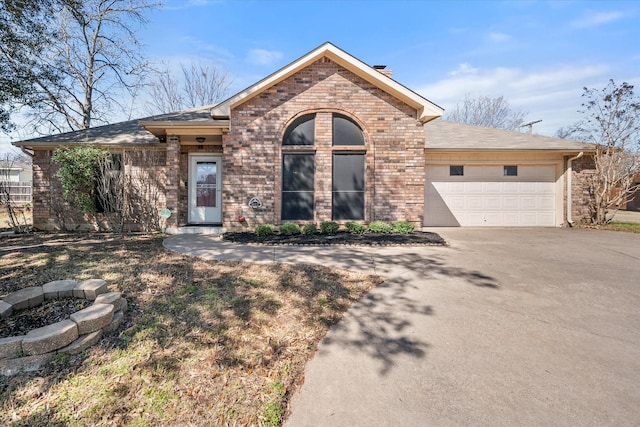 ranch-style home featuring brick siding, concrete driveway, and a garage