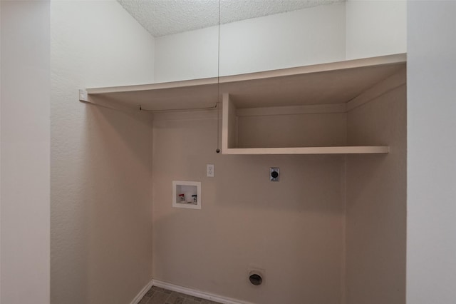 washroom featuring baseboards, laundry area, hookup for a washing machine, hookup for an electric dryer, and a textured ceiling