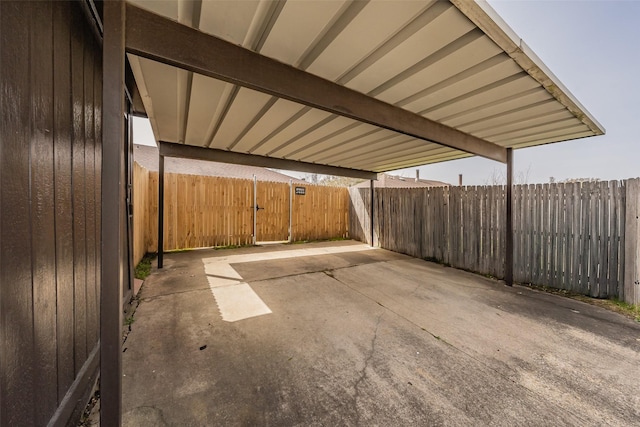 view of patio with a carport and fence