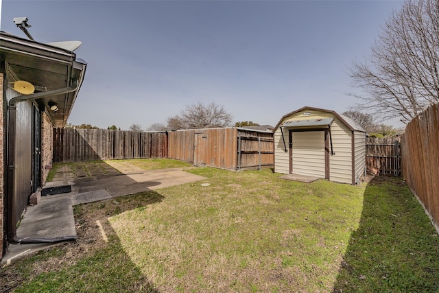 view of yard featuring an outbuilding, a patio, a storage shed, and a fenced backyard