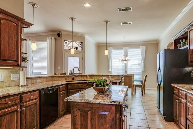 kitchen featuring black appliances, tasteful backsplash, visible vents, and a sink