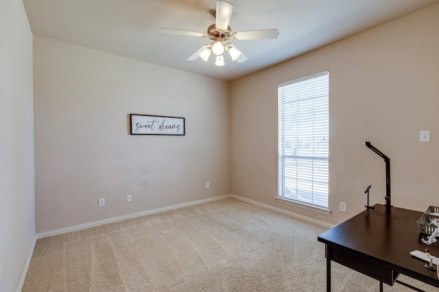 unfurnished office with baseboards, carpet, and a ceiling fan