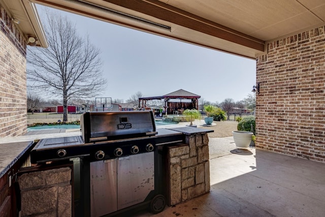 view of patio / terrace featuring a gazebo and a grill