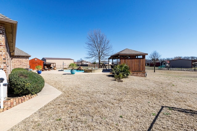 view of yard with a gazebo, a fenced in pool, fence, and a patio area