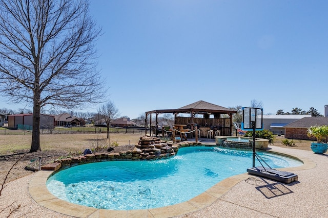 view of swimming pool with a gazebo, a patio area, fence, and a pool with connected hot tub