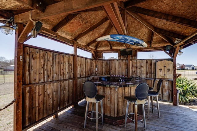 wooden deck with a gazebo and outdoor dry bar