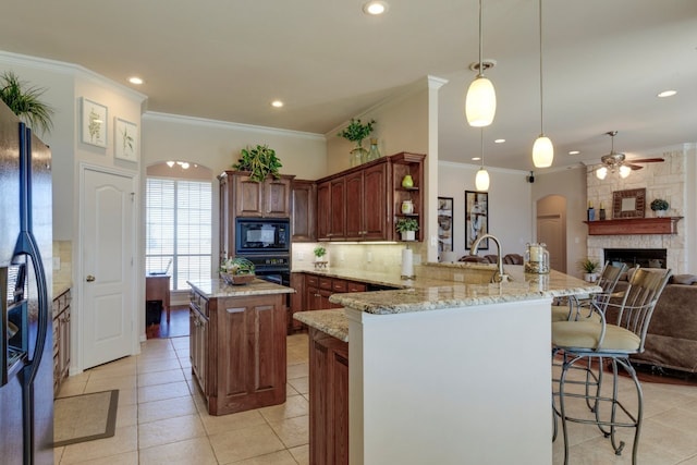 kitchen with tasteful backsplash, a kitchen bar, arched walkways, black appliances, and open shelves