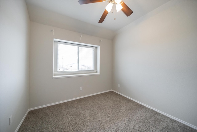 carpeted empty room with lofted ceiling, baseboards, and ceiling fan